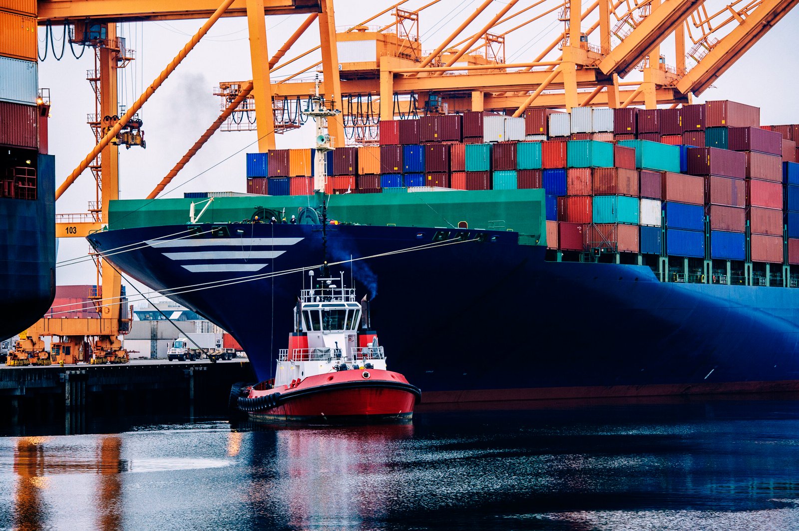 container ship and tugboat in harbor, tacoma, washington, usa